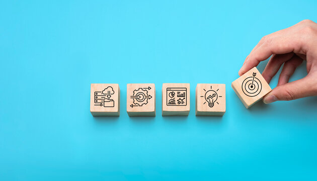 Business automation strategy concept with wooden blocks showing cloud data process optimization analytics dashboard growth idea and target icons for digital transformation