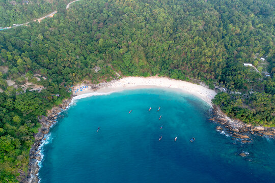 Experience vacation freedom watching Patong beach, tropical jungle, and clear ocean on an island in Phuket Thailand during a peaceful sunrise.