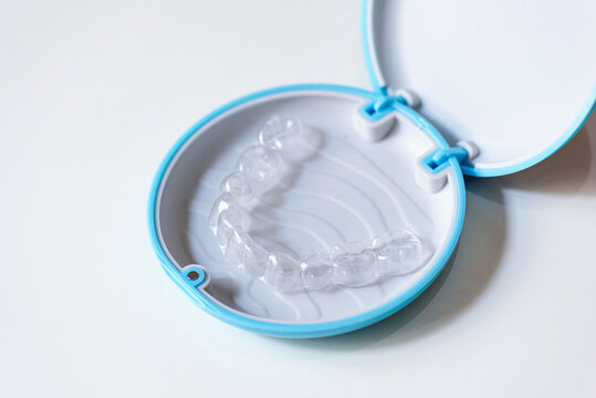  clear aligners device in the mouth on a white background. (invisalign)