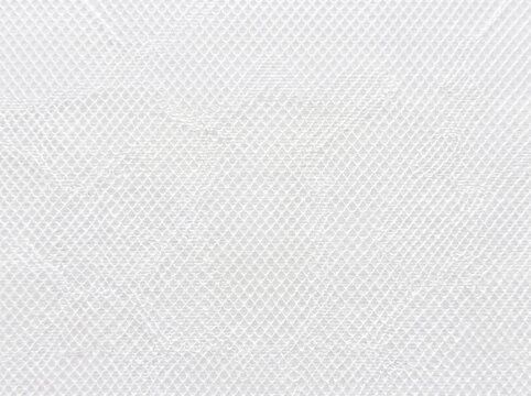 White textured surface with a subtle diamond pattern, showing a clean and minimalist background.