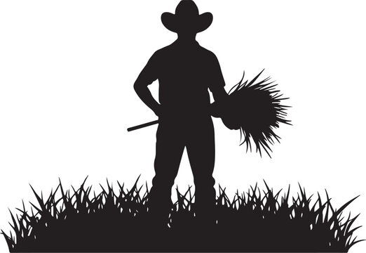 Silhouette of a farmer standing with a bundle of hay