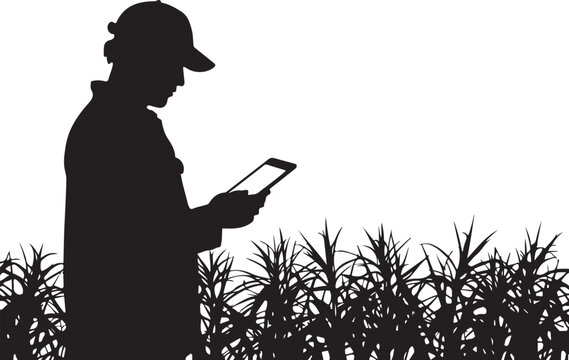 Silhouette of a man in a cap, using a tablet, standing field