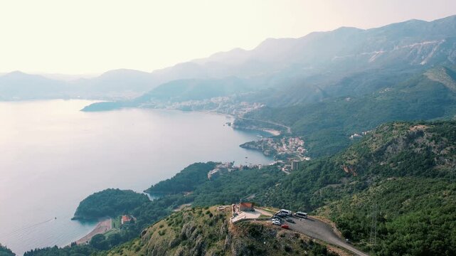 Sunset coast view. Panoramic aerial of coastal landscape. High altitude view capturing bay and mountain silhouettes