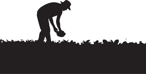 Obraz premium Silhouette of a person planting or harvesting in a field