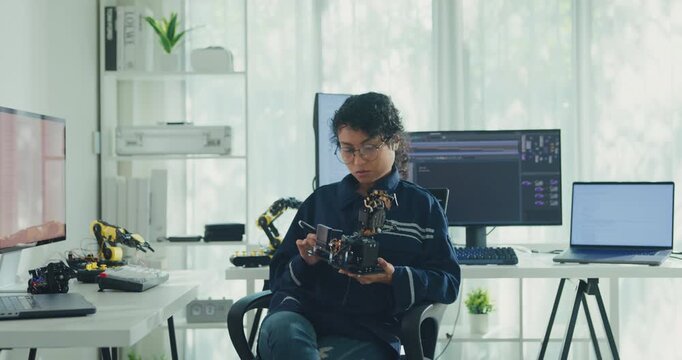 Young Black female engineer coding AI robot arm in modern laboratory. Robotics, artificial intelligence, technology, stem, future, innovation, diversity, automation, machine learning concept.