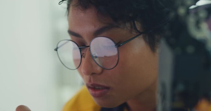 Close-up young Black female engineer coding AI robot arm in modern laboratory. Robotics, artificial intelligence, technology, stem, future, innovation, diversity, automation, machine learning concept.