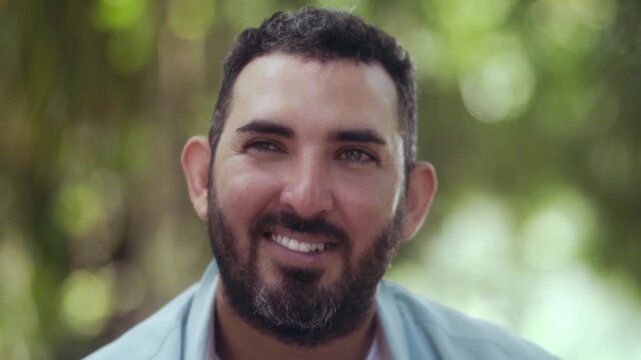 Bearded adult male looking at the camera outdoors