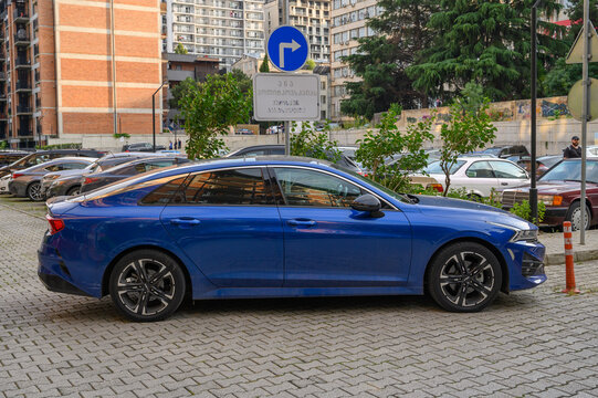 June 24, 2026, Tbilisi, Georgia Blue Kia K5 Mid Size Sedan 2021 2022 with Thin Spoke Alloy Wheels