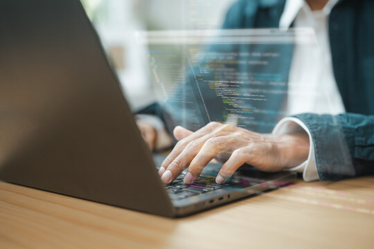 Programmer coding software on a laptop with source code displayed on screen, representing software development, web application engineering, artificial intelligence.