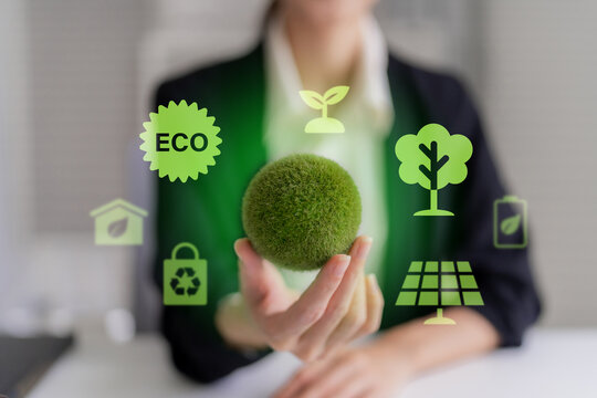 Sustainable business and environmental responsibility concept with businesswoman holding green sphere with eco technology icons