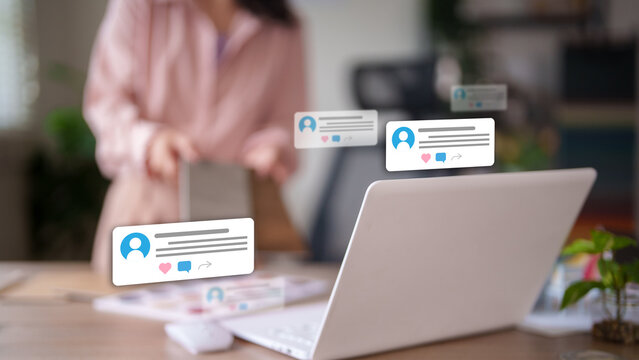 Social media engagement and online communication concept with digital notification icons floating over laptop computer