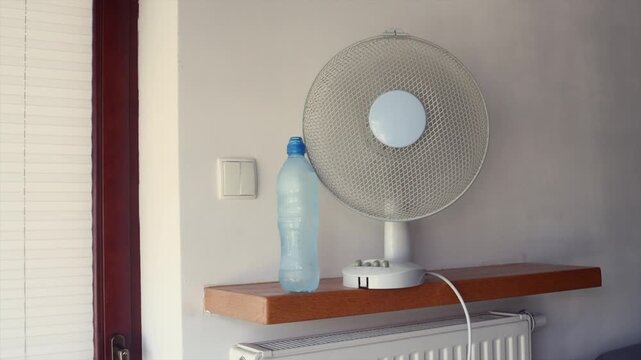 Home remedies to keep your apartment cooler during summer heatwave, cool your apartment without air conditioning using a fan and frozen water bottles