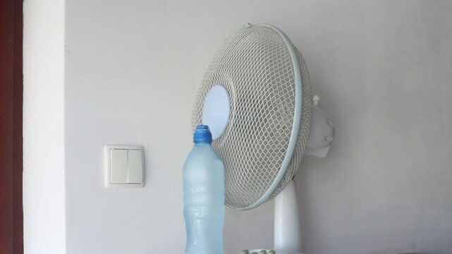 Home Remedies to Keep Your Apartment Cooler During Summer Heatwave, cool your apartment without air conditioning using a fan and frozen water bottles