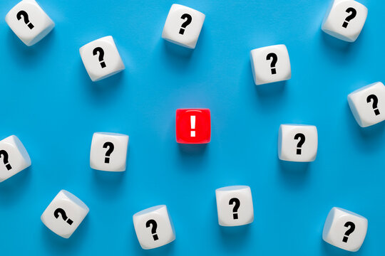 single red exclamation mark among many question marks. isolated on blue background. concept of problem solving