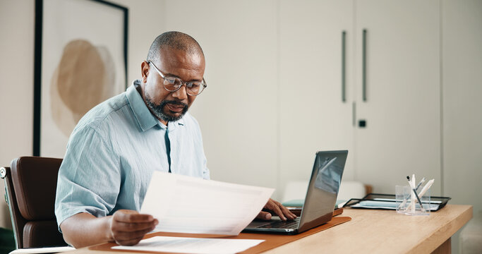 Laptop, finance and black man with documents in home for budget planning, audit or expenses. Mature person, accounting or paperwork with computer for financial assessment, review or report in house