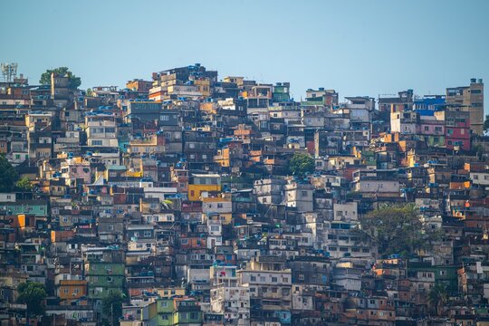 View of the dense urban landscape of Rocinha favela, featuring stacked brick houses, colorful facades, and narrow alleyways in Rio de Janeiro, Rio de Janeiro, Brazil.