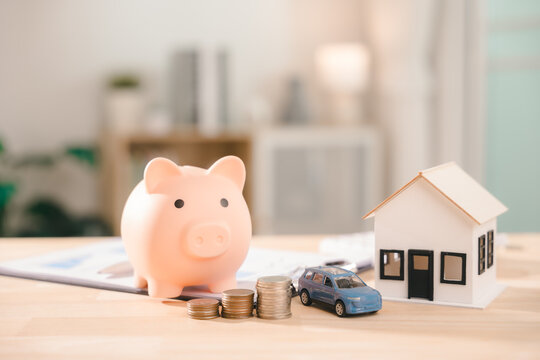 Wealth and financial investment increase visible in piggy bank, house model represents real estate mortgage loan, blue car toy shows insurance management for property assets and documents