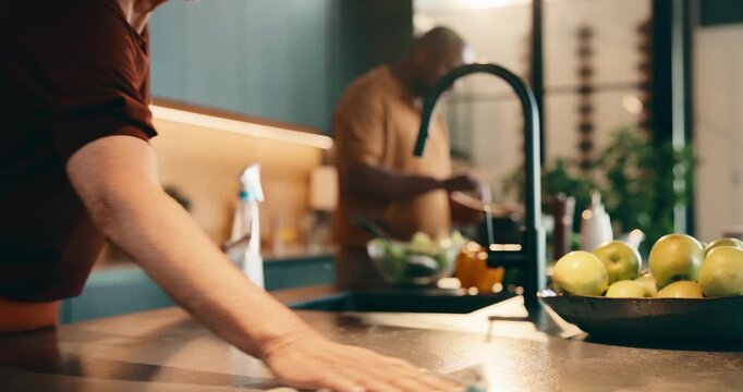 Cleaning, counter and couple in kitchen for cooking, meal prep and share tasks for marriage. Housework, helping and man with woman in home for disinfection, wipe and hygiene with food for dinner