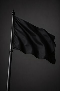 Realistic black flag waving gracefully on a sturdy metal pole against a dark moody background