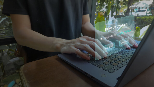 Close Up of Person Typing on Laptop with Floating Digital Privacy Consent Form Representing Online Data Protection and User Agreement