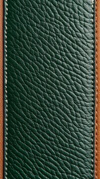 Close-up of textured green leather material with contrasting brown stitching along edges