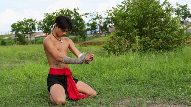 Thai Martial Arts Fighter Performing Traditional Wai Kru Ritual Outdoors