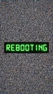 Video sequence displaying a digital rebooting message with glitch effects and pixelation