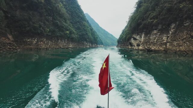 Boat With Chinese Flag Cruising Through The Steep, Forested Gorges Of The Furong River In Wulong District, China. - wide shot