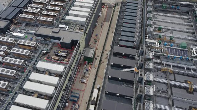 Aerial view of a large data center facility with rows of cooling units and technical infrastructure on the rooftops in London, London, United Kingdom.