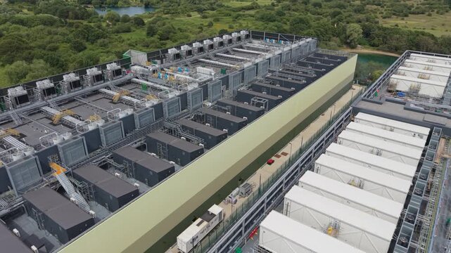 Aerial view of large data center facility with rows of cooling units and industrial infrastructure on the roof in London, London, United Kingdom.