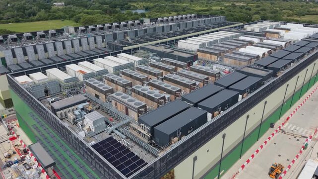 Aerial view of the rooftop of a large data center featuring rows of cooling units and industrial infrastructure in London, London, United Kingdom.