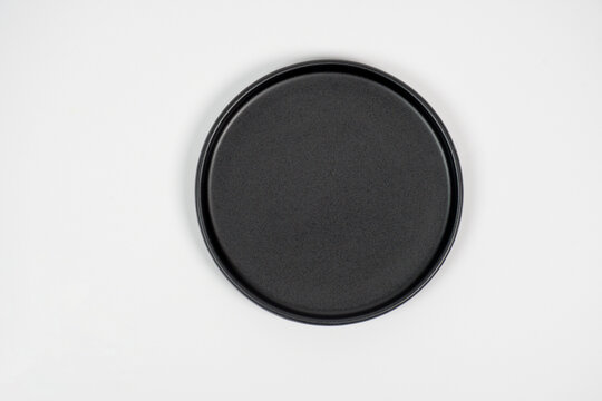 A black, oval-shaped plate with a white background.