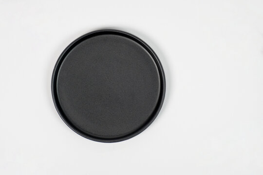A black, oval-shaped plate with a white background.