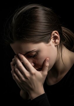 Sad woman covering her face.