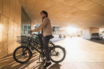 Fototapeta premium Asian man standing with bicycle in soft light