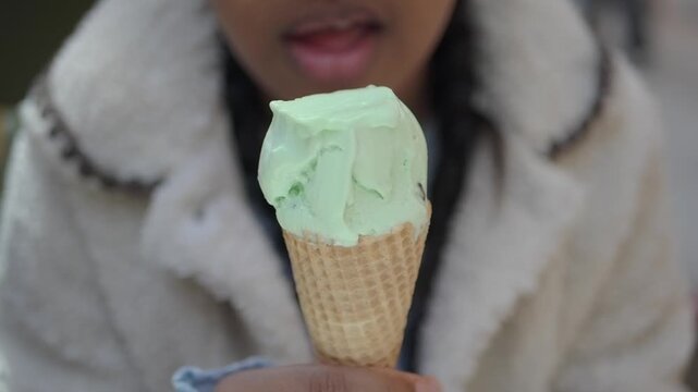 Enjoying ice cream cone in a park on a sunny day