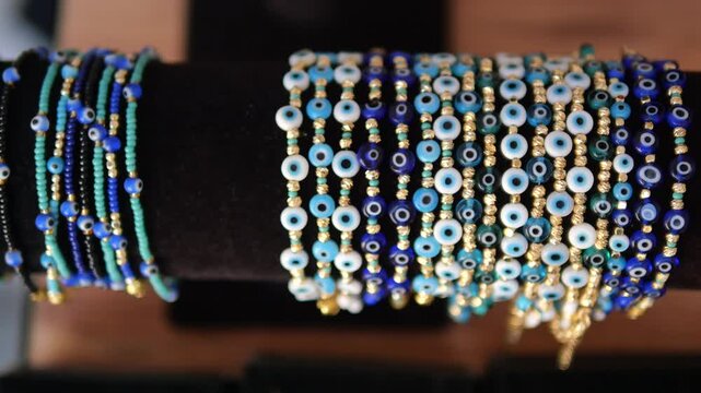 Beaded bracelets on display at a market in vibrant colors