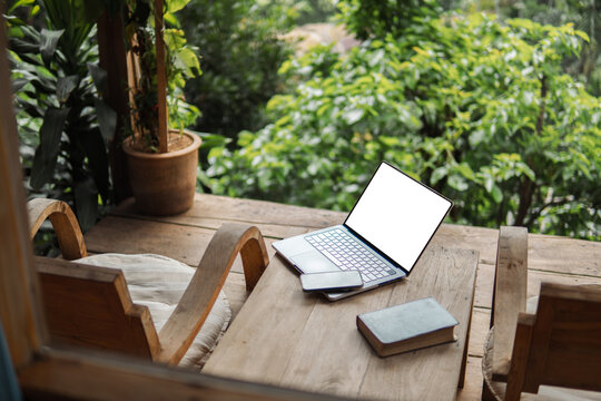Mockup blank screen computer with blank white background. Workspace, desktop computer, homestay balcony, surrounded by nature.