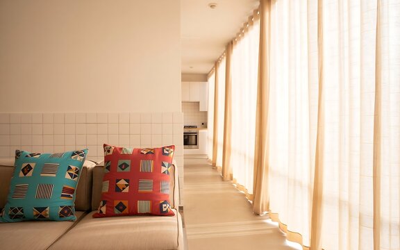 Modern Living Room Interior with Patterned Cushions and Soft Natural Sunlight Filtering In