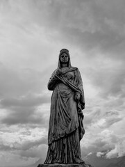 Fototapeta premium Ancient Greek goddess statue under dramatic sky