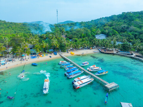 Aerial view of beautiful landscape, tourism boats, and people swimming on the sea and beach on May Rut and Mong Tay island in Phu Quoc, Kien Giang province, Vietnam