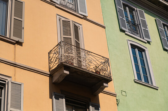 facade of a building with traditional metal balconies and windows with shutters in Europe