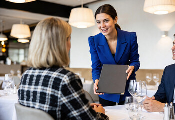 Fototapeta premium Female restaurant manager showing menu card to guests, waitress serving customers in luxury cafe, fine dining, hospitality service, food order, bistro dinner.