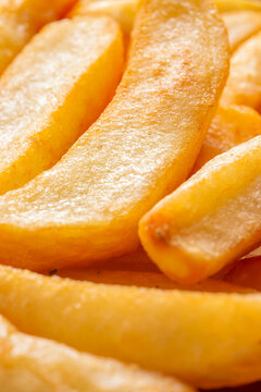 Tripled cooked fried chips background backdrop. Traditional British fried food concept.