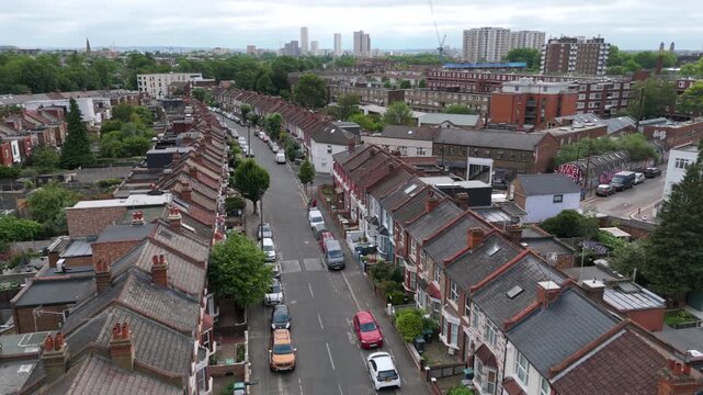 Drone flying over residential crescent shaped curving street in British urban landscape