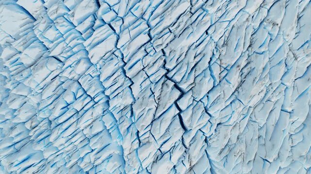 Perito Moreno Glacier in Los Glaciares National Park, Santa Cruz, Argentina, revealing crevasses and compression structures formed by glacial flow, top down drone flyover shot.