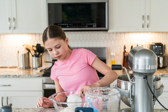 Child Prepares Baking Ingredients at Counter