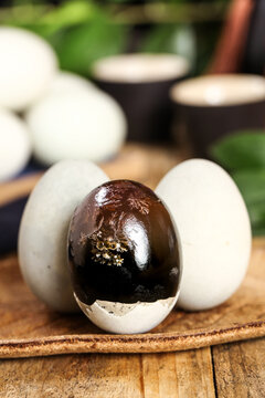 Century Eggs and Fresh White Eggs on Wooden Board - Traditional Asian Food Delicacy Studio Shot