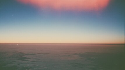 Fototapeta premium Clear open sky with a soft coral blush and muted denim blue gradient, featuring a grainy film aesthetic for background and sky replacement