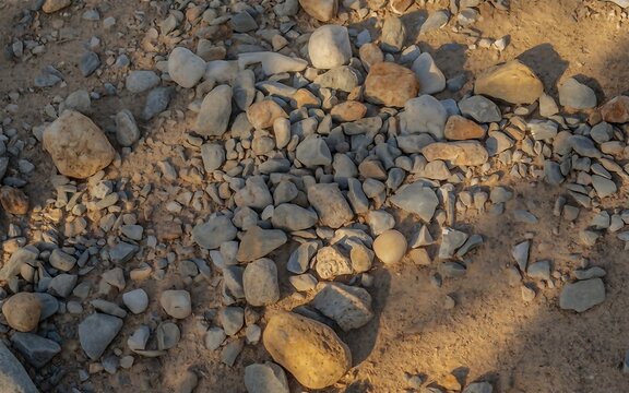 Rugged Earth Terrain Featuring Scattered Natural Gray Stones and Fine Sandy Texture Backdrop
